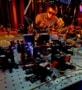 Photo of a researcher wearing laser safety goggles and bending over an optical bench