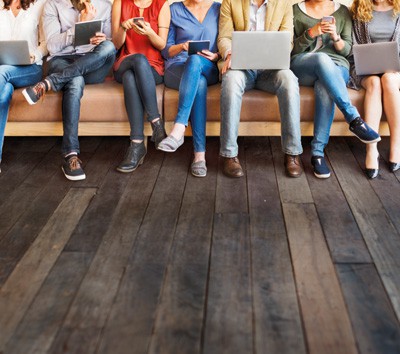 people engrossed in laptops and tablets